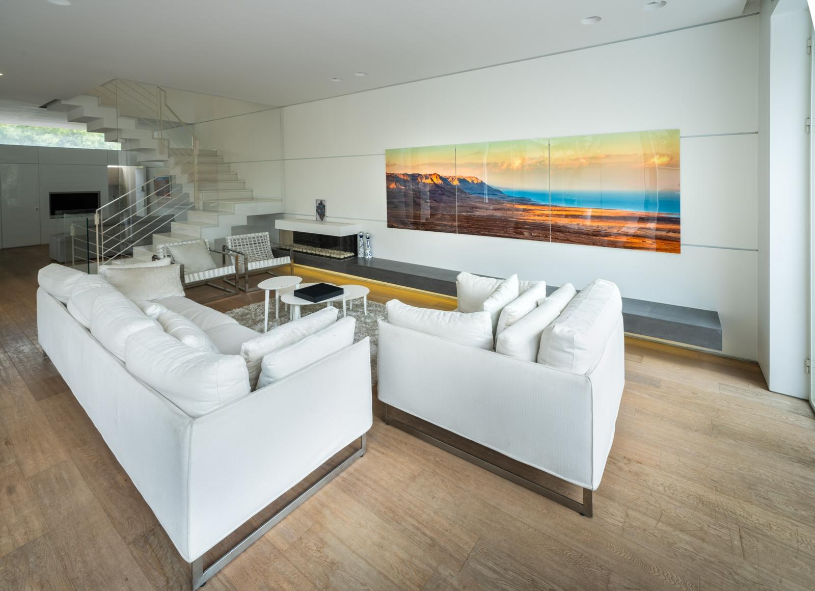 A panoramic piece above a white sectional sofa