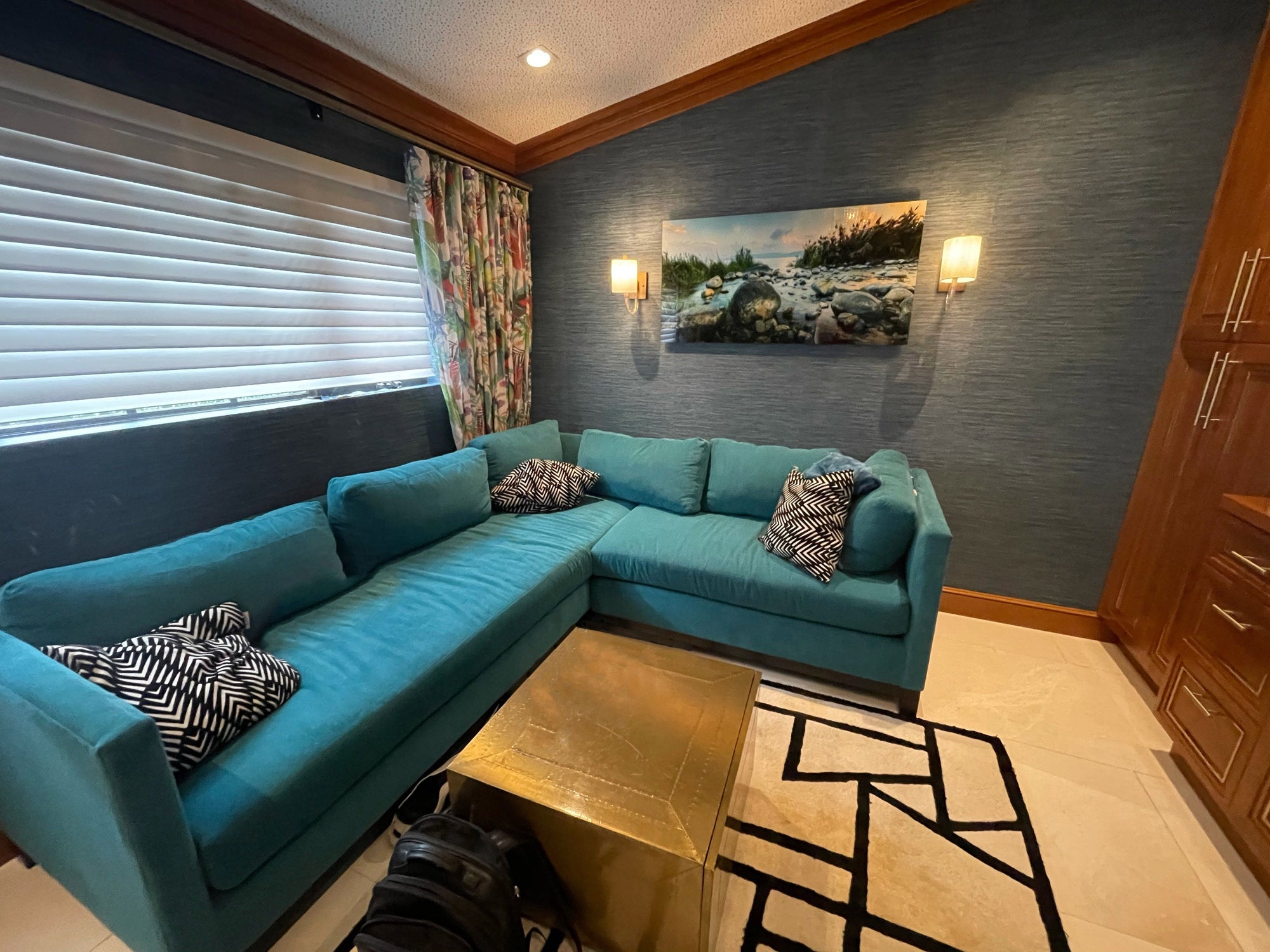 A piece above a teal sofa
